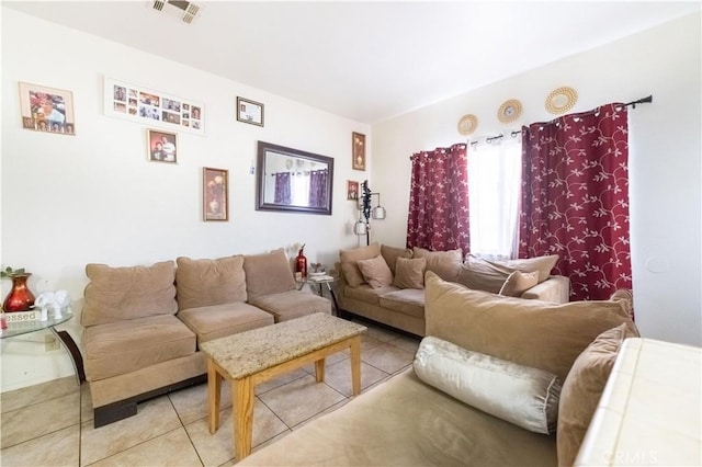 living area with light tile patterned floors and visible vents