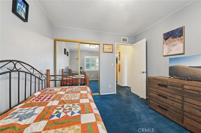 carpeted bedroom with a closet, visible vents, and baseboards