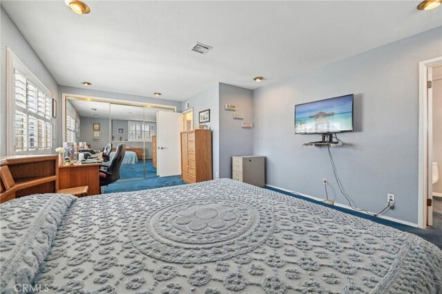 bedroom featuring baseboards, visible vents, multiple windows, and carpet floors