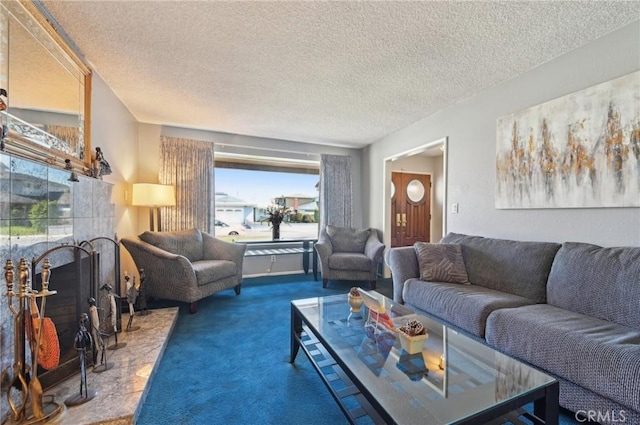 living area with carpet floors, a textured ceiling, and a fireplace