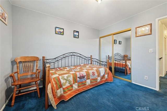 carpeted bedroom featuring a closet and baseboards