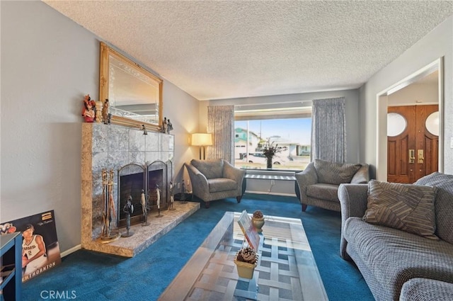 living room with carpet flooring, a fireplace, and a textured ceiling