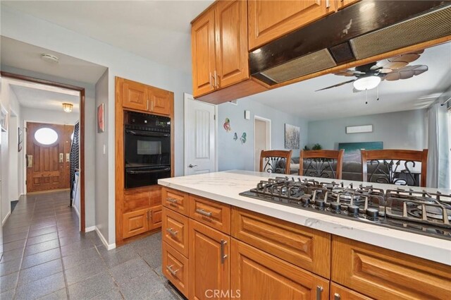 kitchen featuring baseboards, ceiling fan, black appliances, under cabinet range hood, and a warming drawer