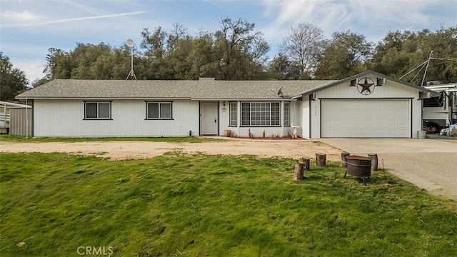 ranch-style house featuring a front yard, an attached garage, and driveway