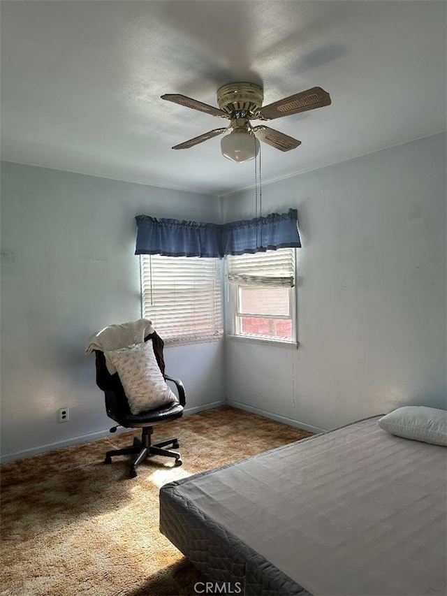 bedroom featuring ceiling fan, baseboards, and carpet