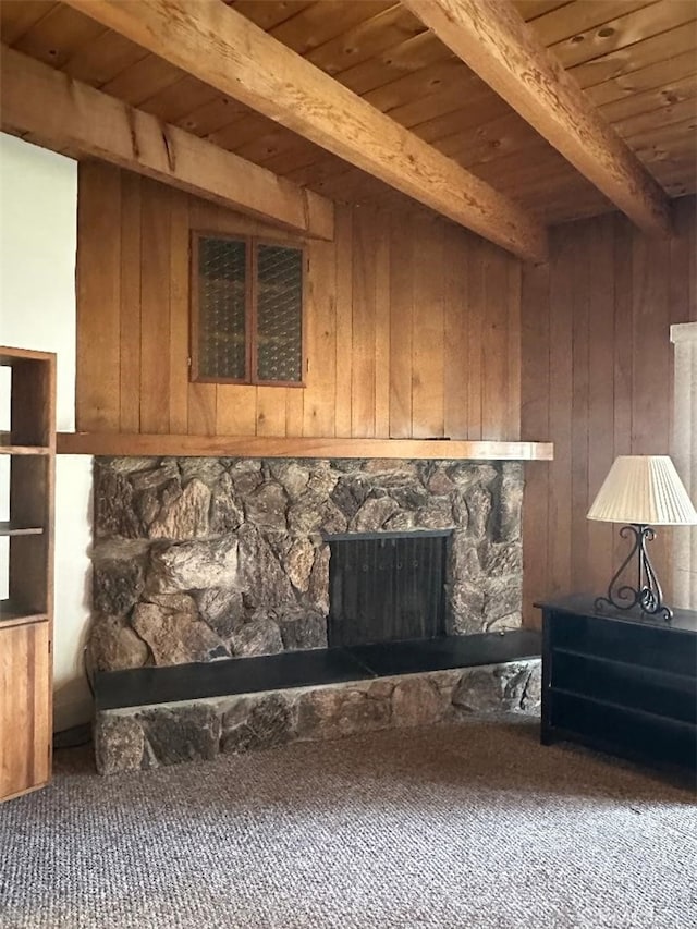 interior space with beamed ceiling, wood ceiling, wood walls, and a fireplace