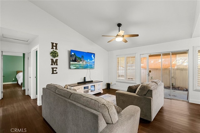 living area featuring baseboards, lofted ceiling, attic access, and dark wood-style flooring