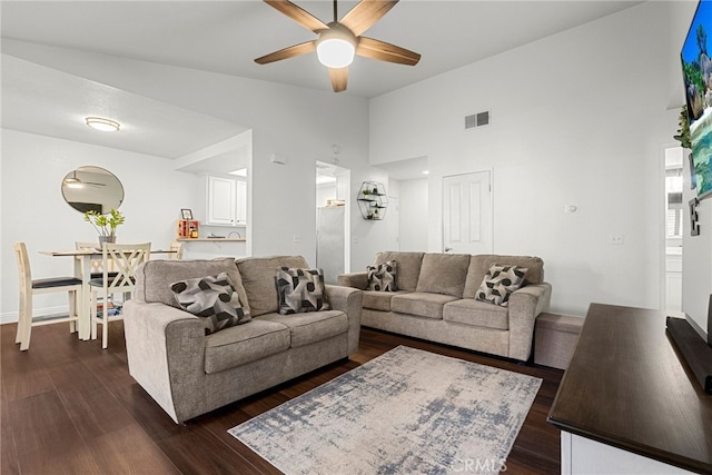 living room featuring visible vents, high vaulted ceiling, dark wood-type flooring, and ceiling fan