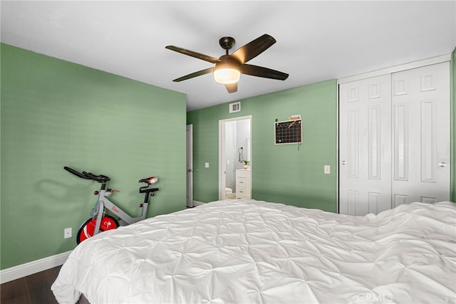 bedroom with visible vents, dark wood-style floors, a closet, baseboards, and ceiling fan