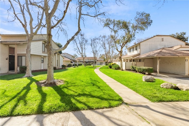 view of community with a yard and a residential view