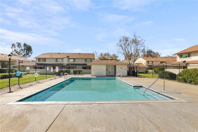 pool featuring a patio area, fence, and a residential view