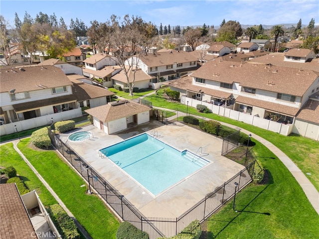 pool featuring a residential view, a lawn, a patio, and fence