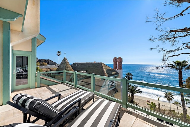 balcony featuring view of water and beach