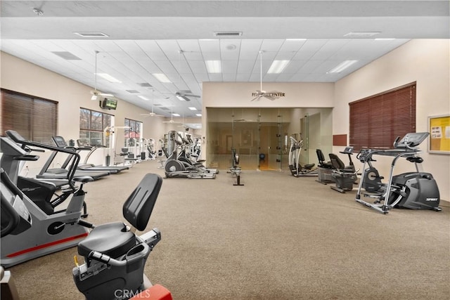 exercise room with a drop ceiling and visible vents