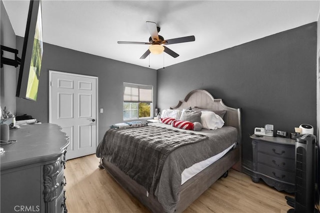 bedroom with a ceiling fan and light wood-style floors