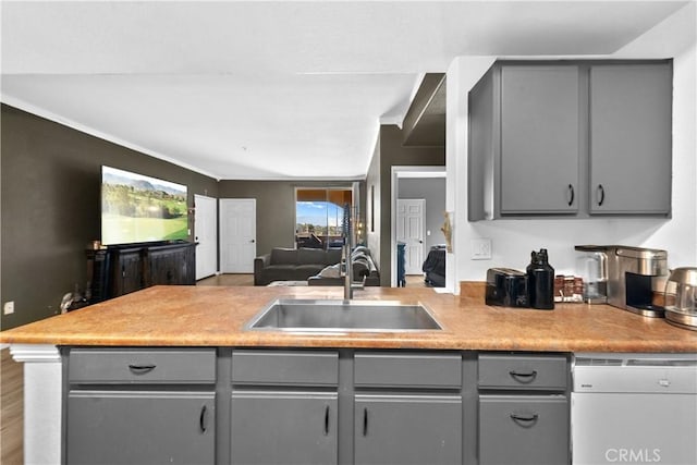 kitchen featuring open floor plan, gray cabinets, white dishwasher, and a sink