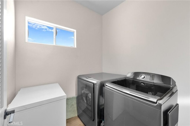 laundry area featuring washing machine and clothes dryer and laundry area