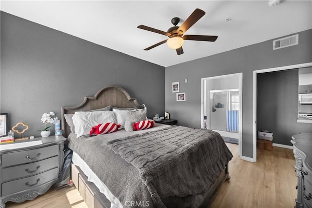 bedroom featuring a ceiling fan, wood finished floors, visible vents, and baseboards