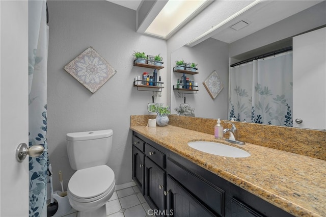 bathroom with baseboards, toilet, a shower with curtain, tile patterned floors, and vanity