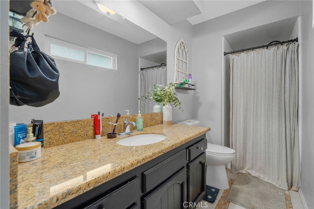 bathroom with tile patterned floors, toilet, vanity, and a shower with shower curtain