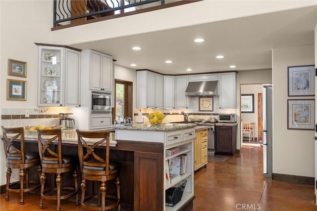 kitchen featuring under cabinet range hood, open shelves, recessed lighting, stainless steel appliances, and decorative backsplash