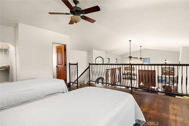 bedroom with lofted ceiling and wood finished floors