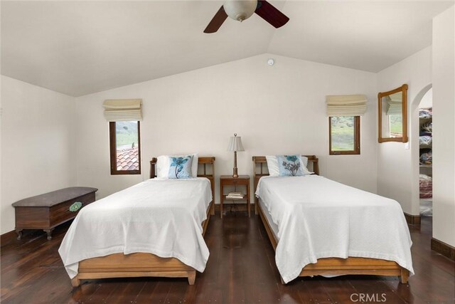 bedroom with a ceiling fan, lofted ceiling, and wood finished floors