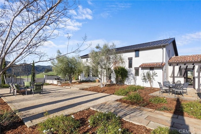 surrounding community featuring a patio area