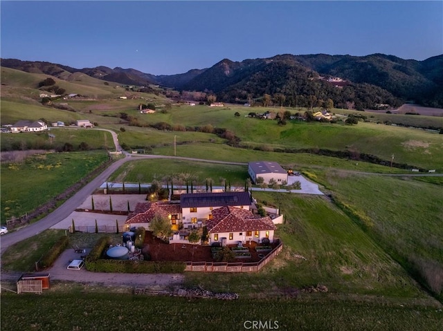 drone / aerial view with a mountain view and a rural view