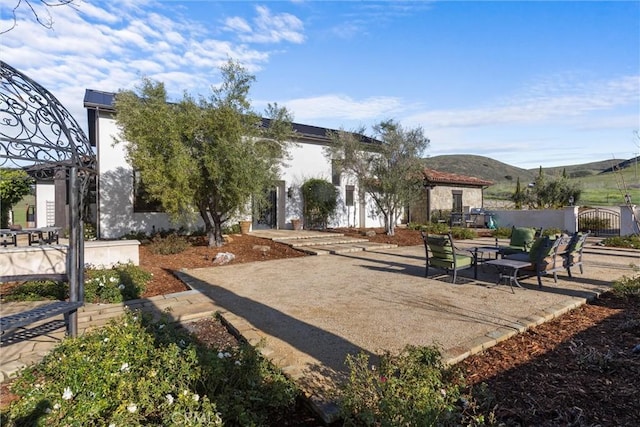 exterior space with a mountain view and a patio