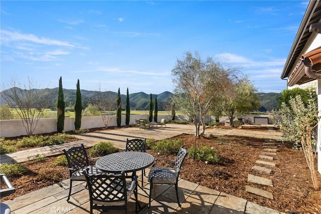 view of patio / terrace featuring outdoor dining area and a mountain view