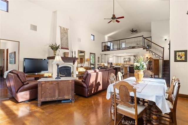 interior space with high vaulted ceiling, finished concrete flooring, visible vents, and ceiling fan