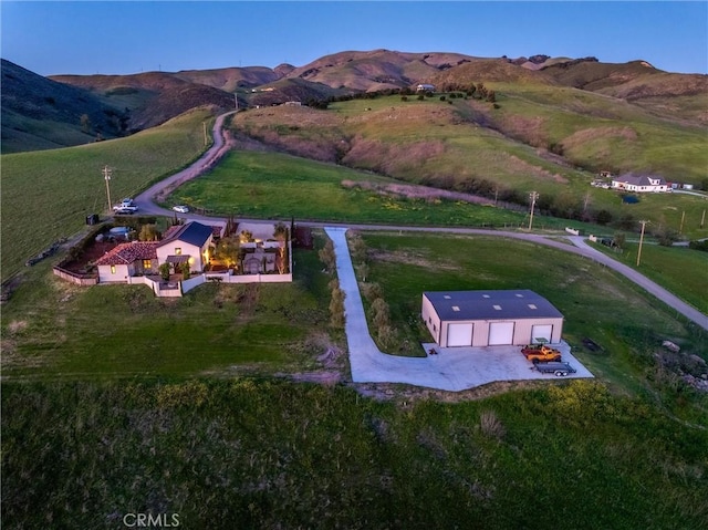 birds eye view of property with a mountain view and a rural view