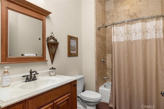 bathroom featuring toilet, shower / tub combo with curtain, and vanity