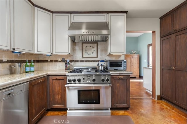 kitchen featuring stainless steel appliances, backsplash, exhaust hood, and light countertops