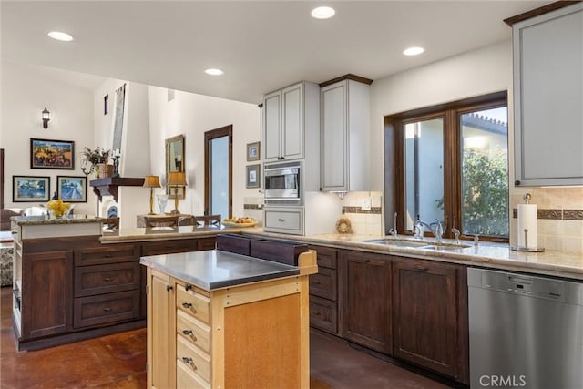 kitchen featuring a sink, recessed lighting, tasteful backsplash, and stainless steel appliances