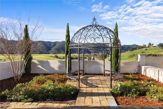 view of yard featuring a mountain view and fence