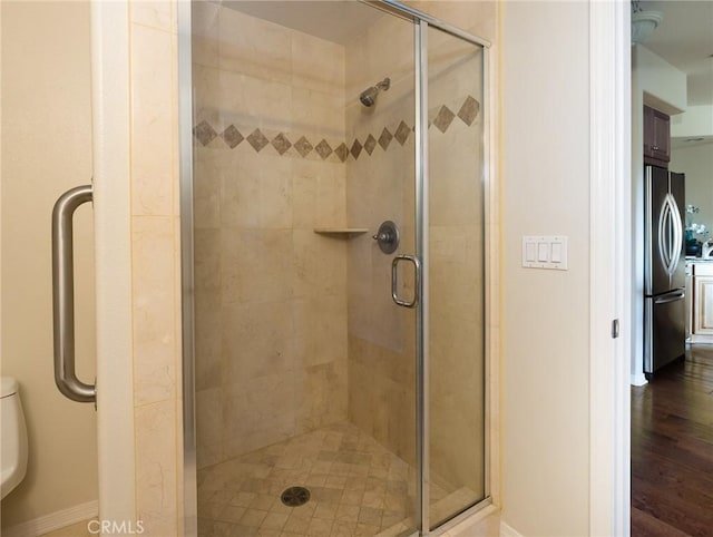 21345 Hawthorne Blvd Unit 415, Torrance, CA 90503 - bathroom featuring a shower stall, toilet, and wood finished floors