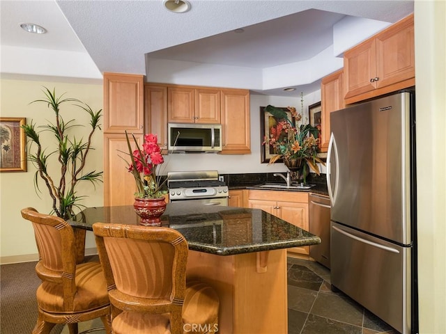 21345 Hawthorne Blvd Unit 415, Torrance, CA 90503 - kitchen featuring a sink, a breakfast bar area, a kitchen island, and stainless steel appliances