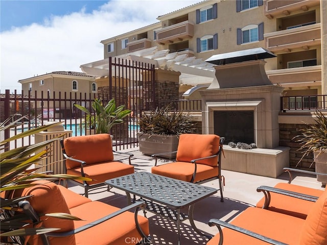 21345 Hawthorne Blvd Unit 415, Torrance, CA 90503 - view of patio / terrace featuring exterior fireplace, a community pool, and fence