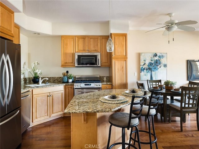 21345 Hawthorne Blvd Unit 415, Torrance, CA 90503 - kitchen featuring a sink, dark wood-style floors, appliances with stainless steel finishes, a breakfast bar area, and light stone countertops