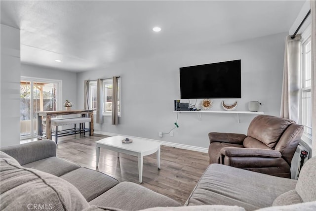 living room featuring recessed lighting, wood finished floors, and baseboards