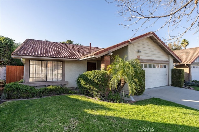 ranch-style home featuring a tile roof, concrete driveway, a front yard, stucco siding, and a garage