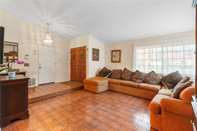 living room featuring vaulted ceiling, baseboards, and visible vents