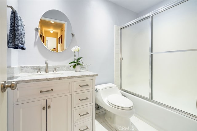 full bathroom featuring tile patterned floors, toilet, vanity, and bath / shower combo with glass door