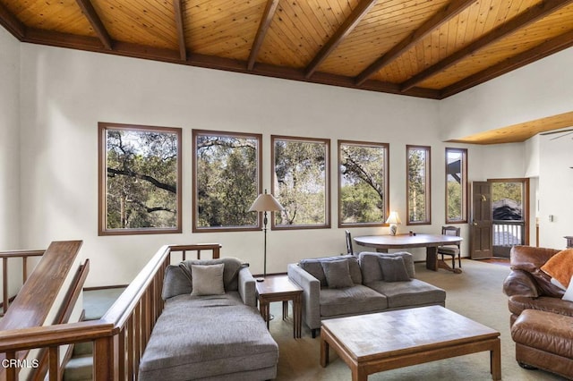 carpeted living room featuring beam ceiling, wood ceiling, and a towering ceiling