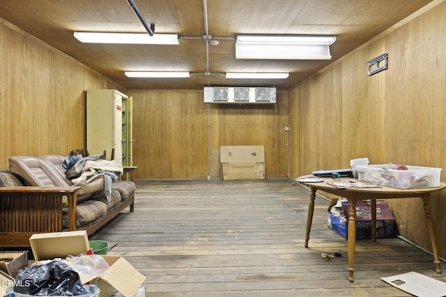 interior space with hardwood / wood-style flooring and wooden walls