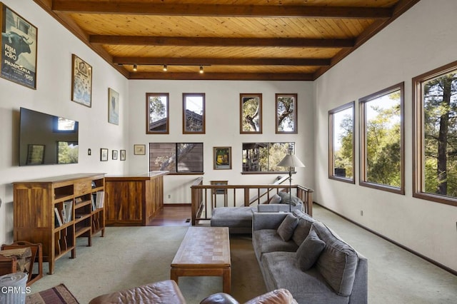 living room featuring beamed ceiling, wood ceiling, and carpet