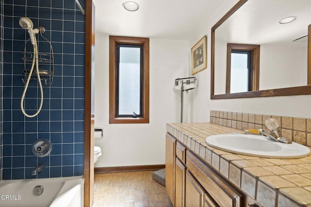 full bath featuring shower / bathtub combination, baseboards, toilet, and vanity