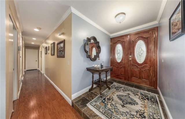 foyer with dark wood-style floors, baseboards, and ornamental molding